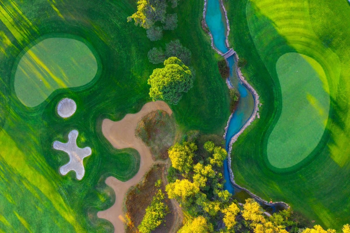 Montgomerie Maxx Royal Golf Course from the air with plants, bunker and putting green below