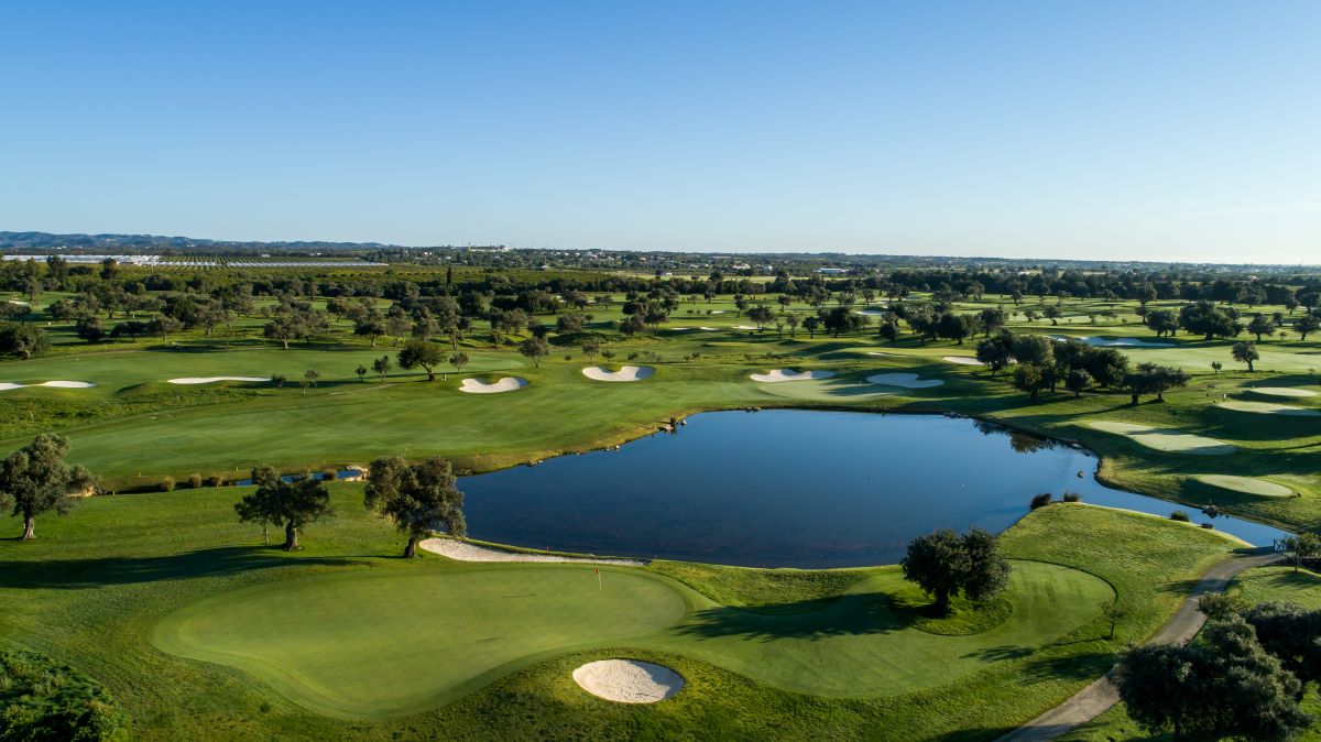 Blue lake surrounding Quinta Da Ria Golf Club Ria Course