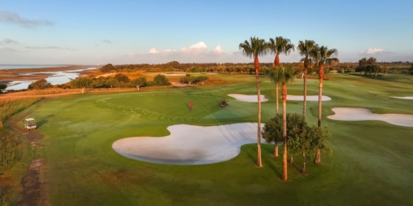 Quinta Da Ria Golf Club putting green with trees and bunker protecting the fairways