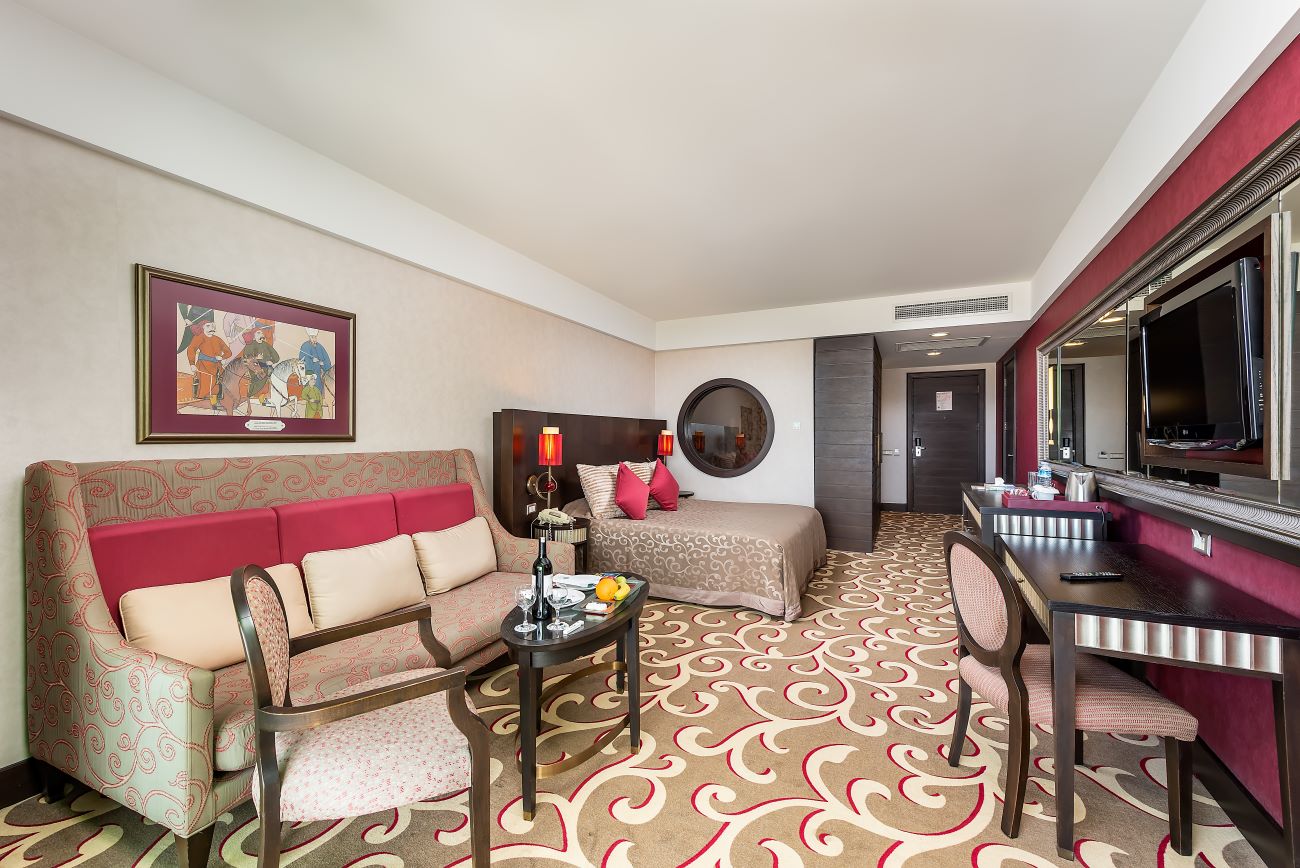 Sofa in classic bedroom with desk and television