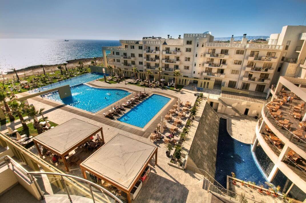 Capital Coast Resort And Spa with views of the swimming pool, sun loungers and sea