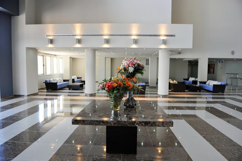 Lobby areas in Capital Coast Resort And Spa with flowers decorating the table on marble floor