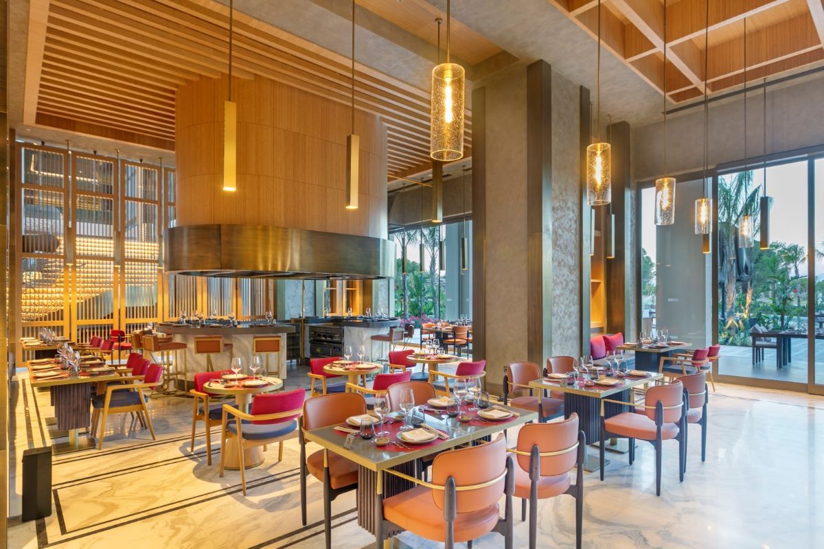 Indoor restaurant with orange chairs at Cullinan Belek Resort in Turkey