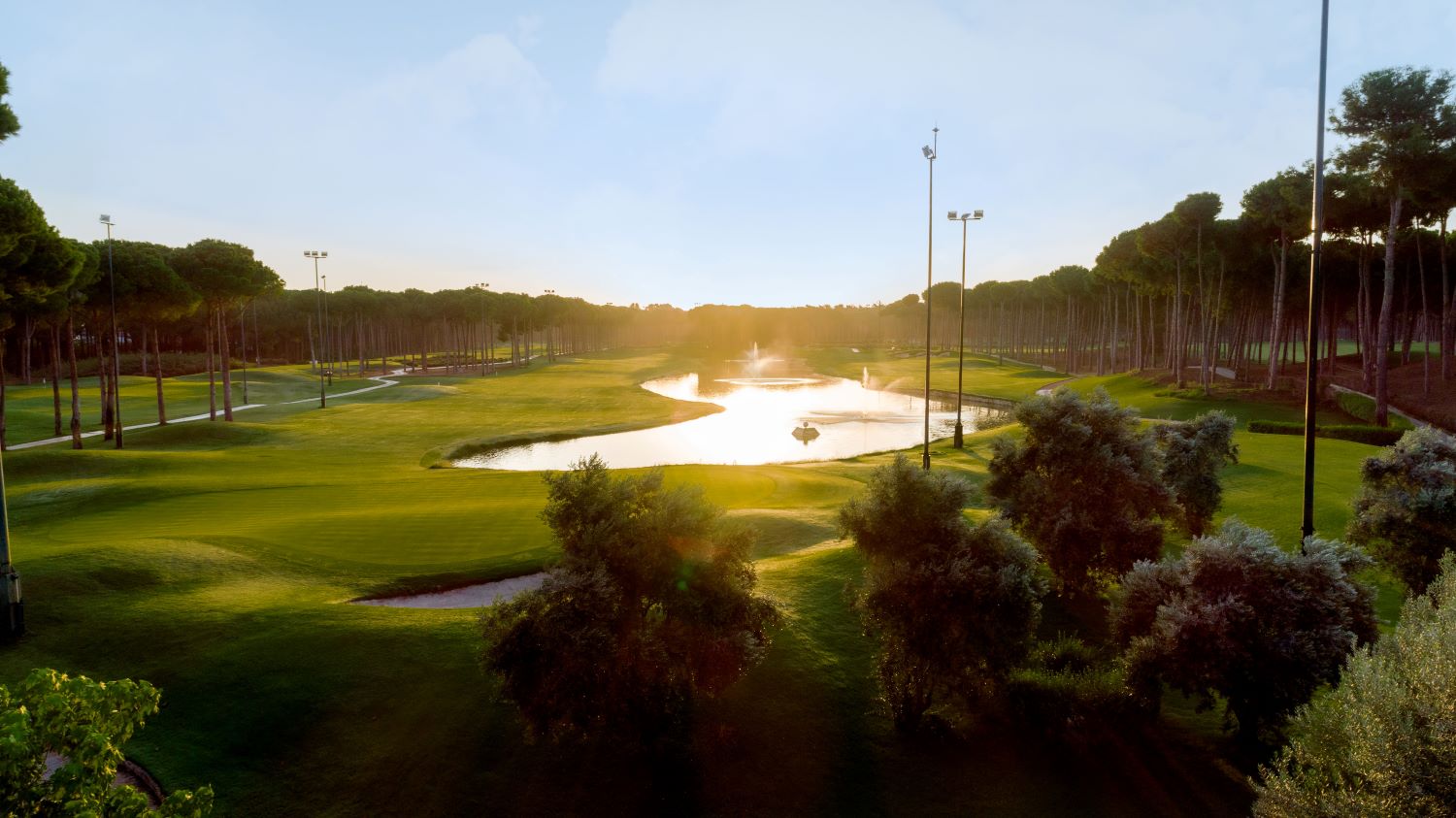 Sunlight bouncing off the lake at Carya Golf Club