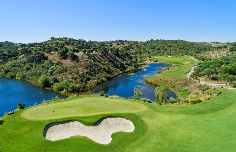 Bunker and lake protecting the putting green at Monte Rei Golf & Country Club