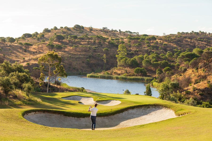 Golfer playing out of bunker at Monte Rei Golf & Country Club