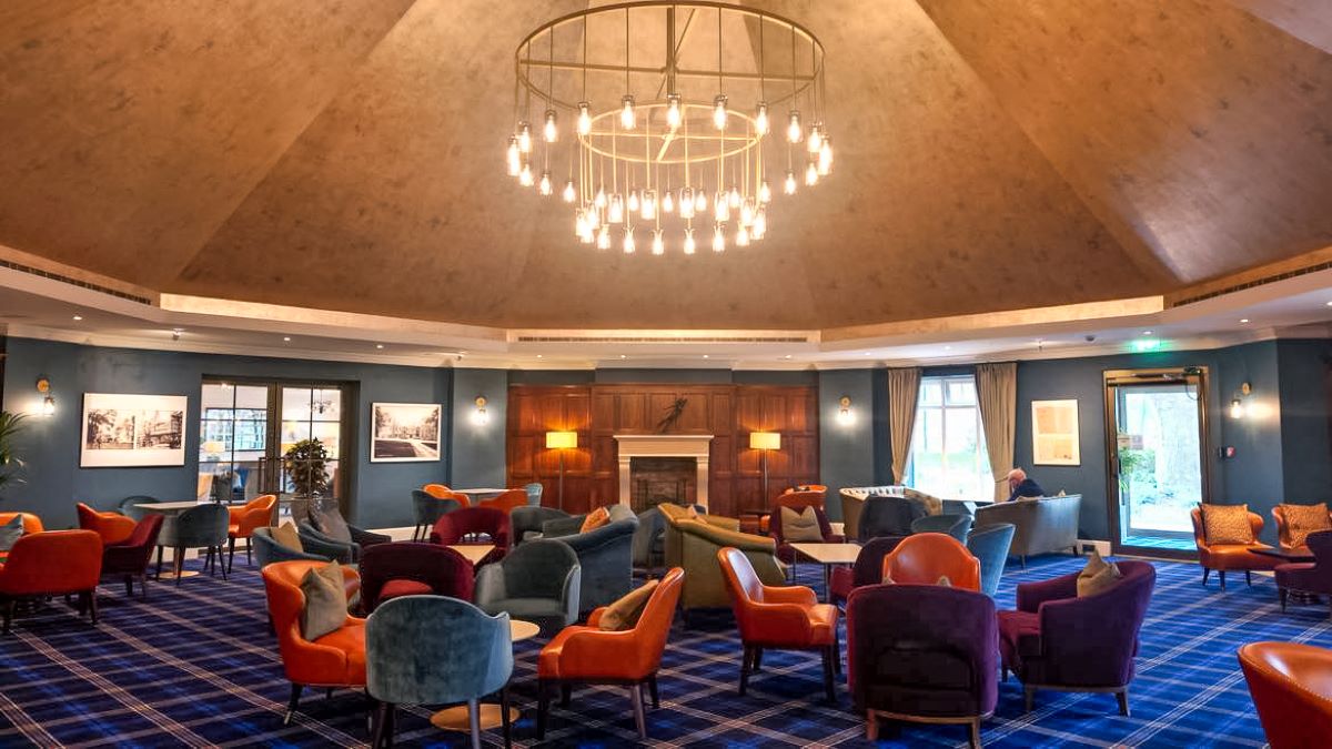 Bar at Carden Park Hotel with blue and red chairs