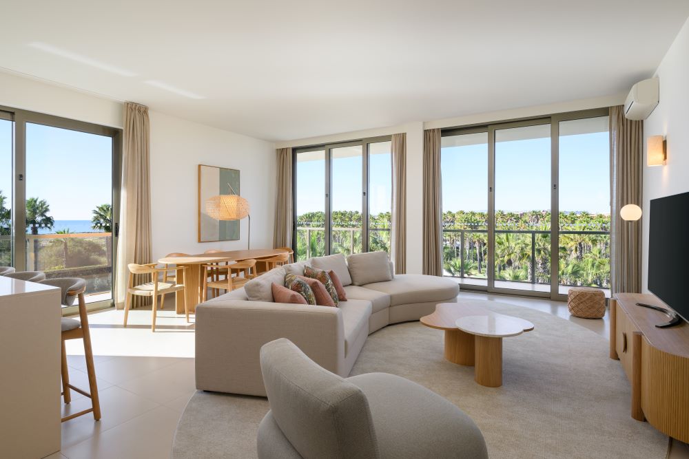 Living area with sofa and large bay window at The Westin Algarve Salgados Beach Resort