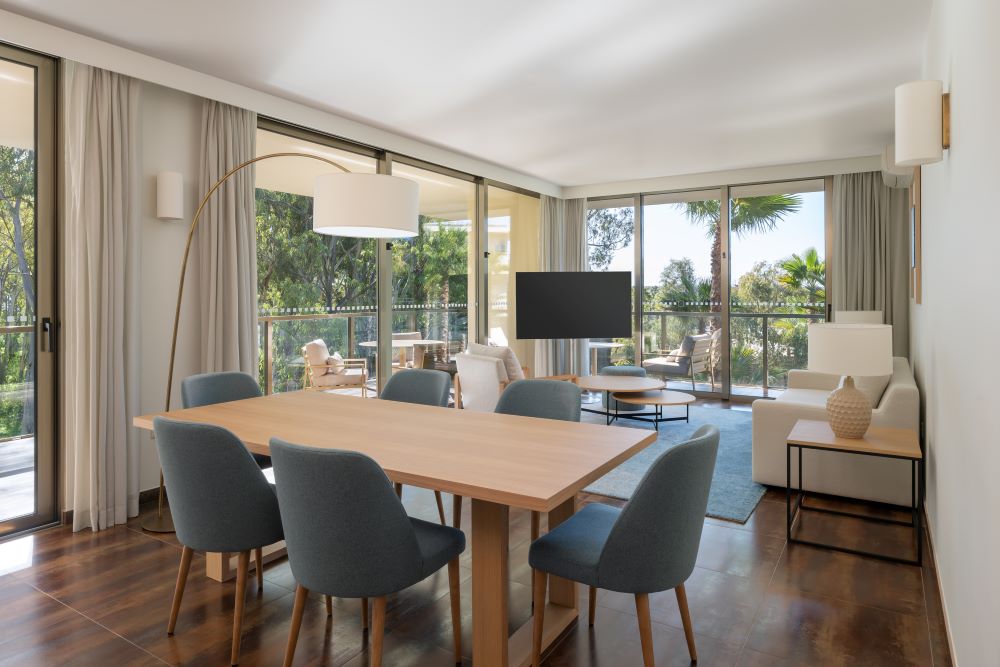 Television in living area with tables and chairs at Marriott Residences Salgados Resort