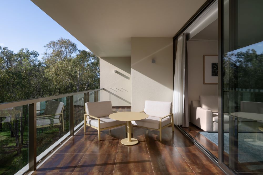 Tables and chairs on wooden floor on balcony at Marriott Residences Salgados Resort in Portugal