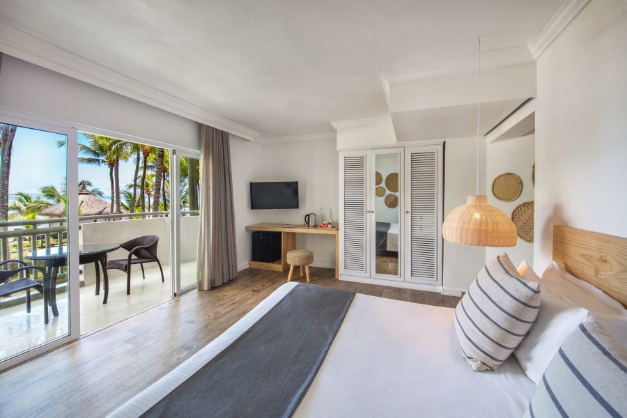 Bedroom with doors and television on wall at Ambre Mauritius