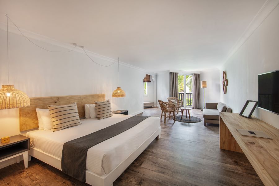 Bedroom and sofa with chairs at Ambre Mauritius resort