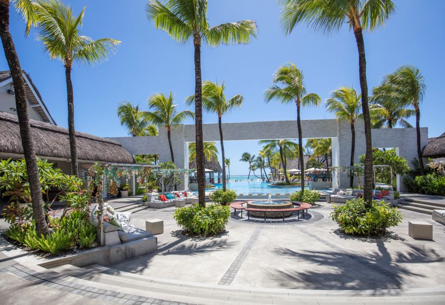 Patio area decorated with palm trees at Ambre Mauritius