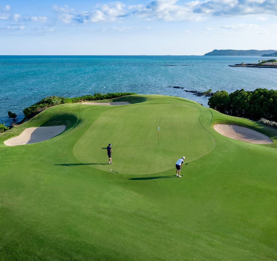 Two golfers approaching the green at Anahita Golf in Mauritius