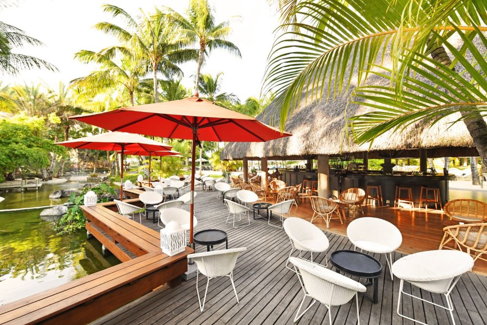 Umbrella over table and chairs in outdoor restaurant at Canonnier Beachcomber Golf Resort & Spa