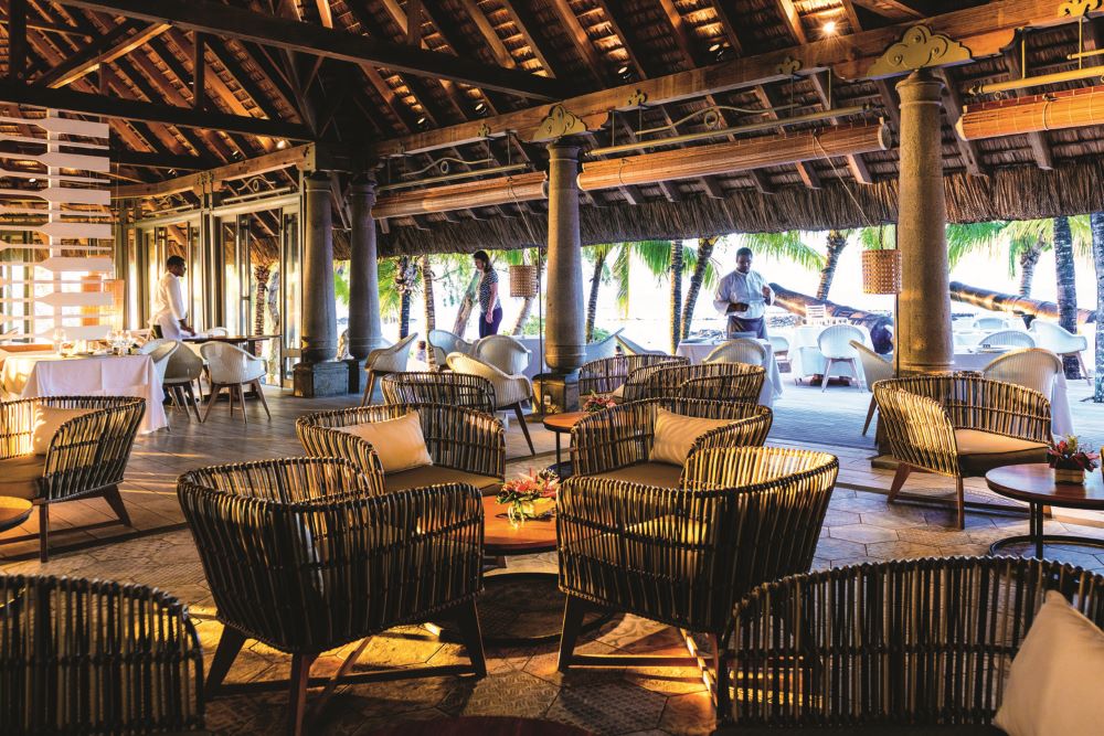 Table and chairs in restaurant at Canonnier Beachcomber Golf Resort & Spa