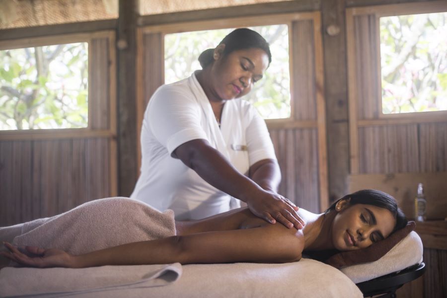 Guest having massage from therapist in Spa at Canonnier Beachcomber Golf Resort & Spa