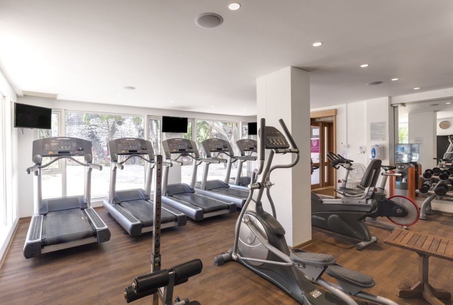 Gym with treadmills and exercise machines at Canonnier Beachcomber Golf Resort & Spa