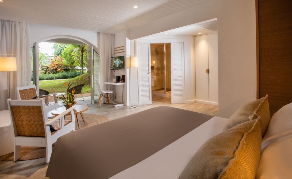 Bed facing the doors, with bathroom on the right at Canonnier Beachcomber Golf Resort & Spa