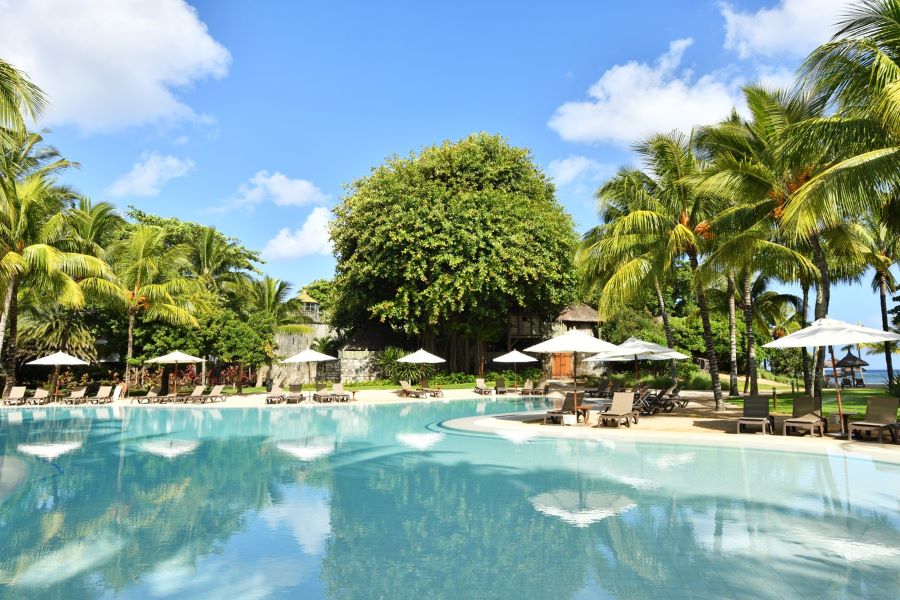 Swimming pool with sun loungers at Canonnier Beachcomber Golf Resort & Spa