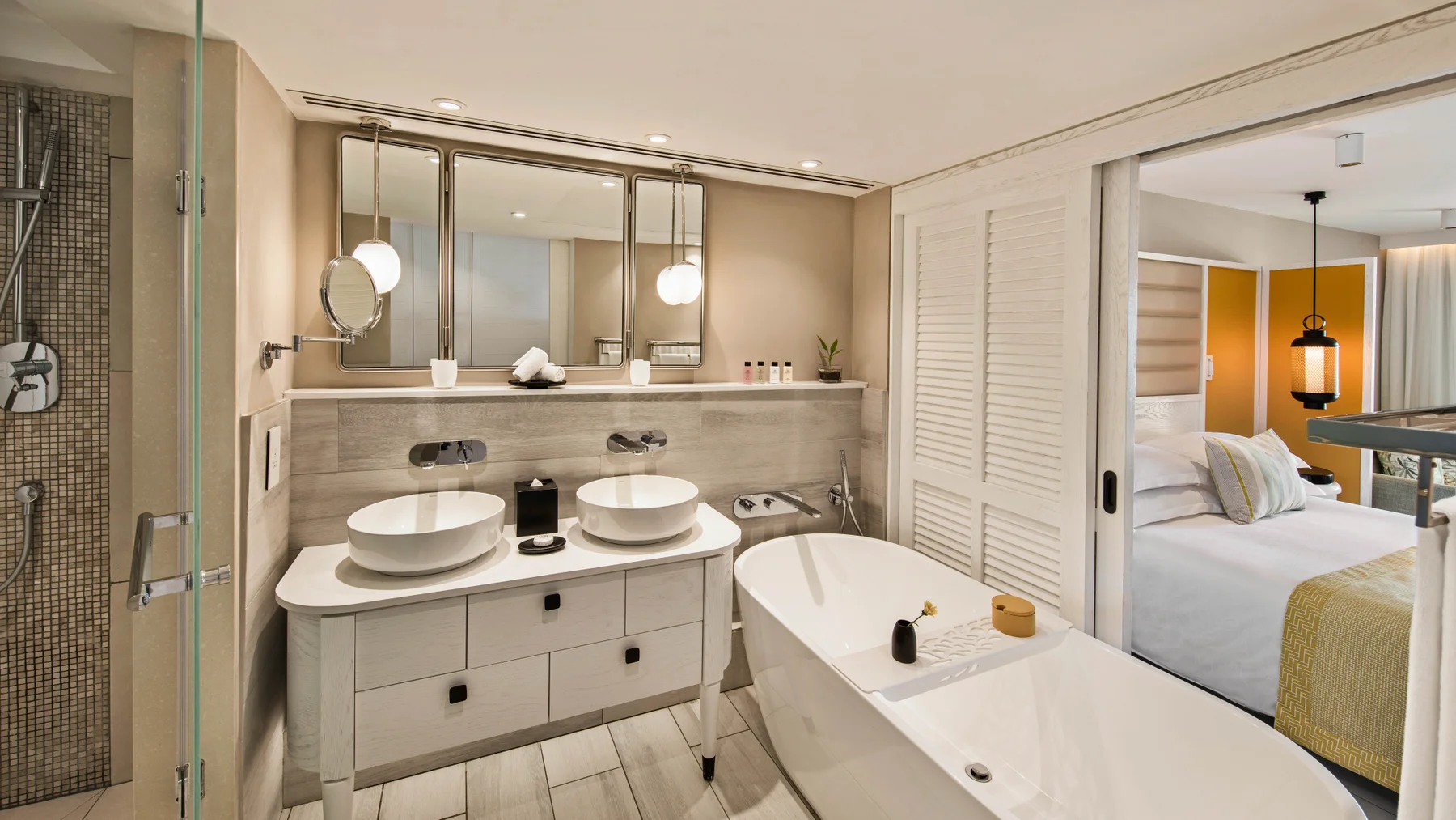 Bathroom with tub and twin sinks and mirror at Constance Belle Mare Plage Hotel Mauritius