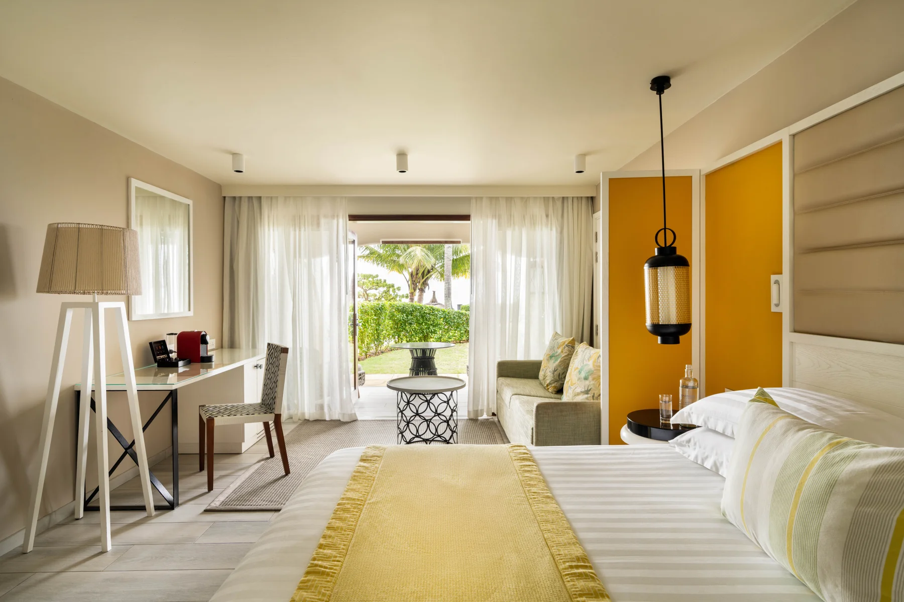 Bedroom with balcony view at Constance Belle Mare Plage Hotel Mauritius