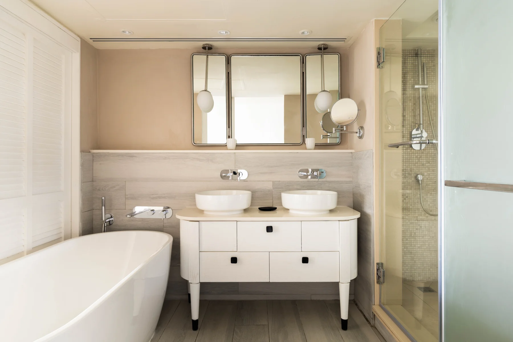 Bathroom with tub and twin sink at Constance Belle Mare Plage Hotel Mauritius