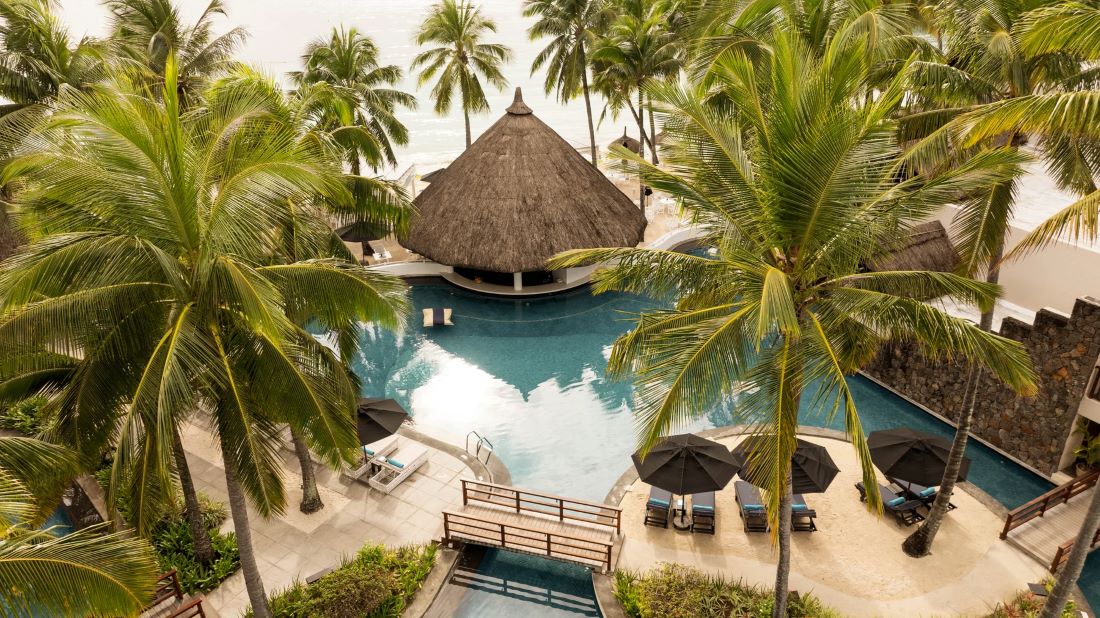 Swimming pool and pool bar at Constance Belle Mare Plage Hotel Mauritius