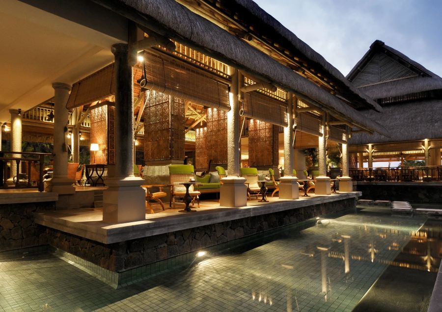 Tables and chairs in bar by swimming pool at Constance Prince Maurice