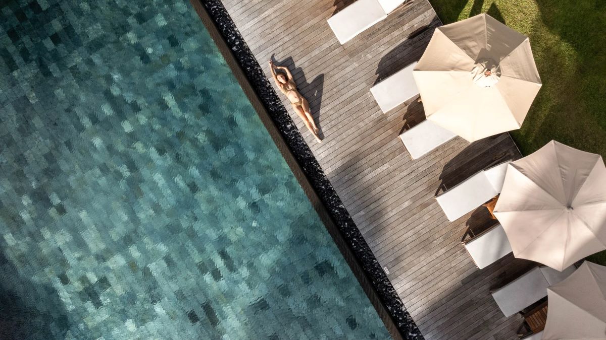 Guest sunbathing on decking at Constance Prince Maurice in Mauritius