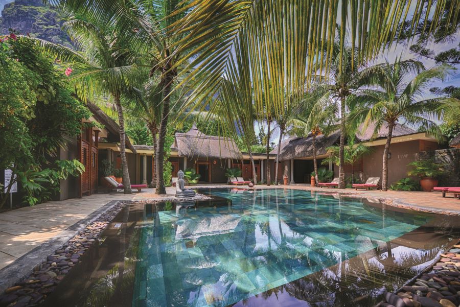 Spa pool area surrounded by huts at Dinarobin Beachcomber Golf Resort & Spa