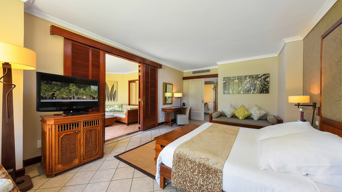 Television on unit in bedroom at Dinarobin Beachcomber Golf Resort & Spa