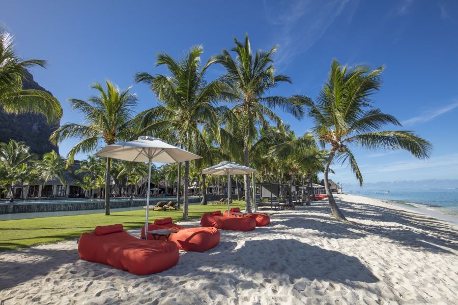 Sun loungers on beach at Dinarobin Beachcomber Golf Resort & Spa