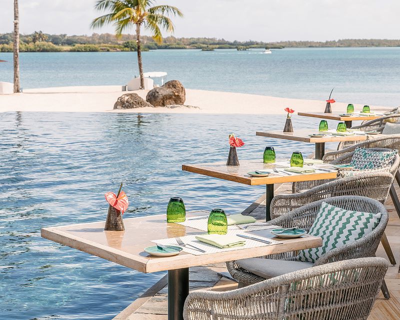 Tables and chairs overlooking the Indian Ocean at Four Seasons Resort Mauritius at Anahita