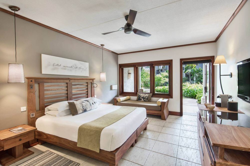 Bedroom with door to gardens at Heritage Awali Golf & Spa Resort