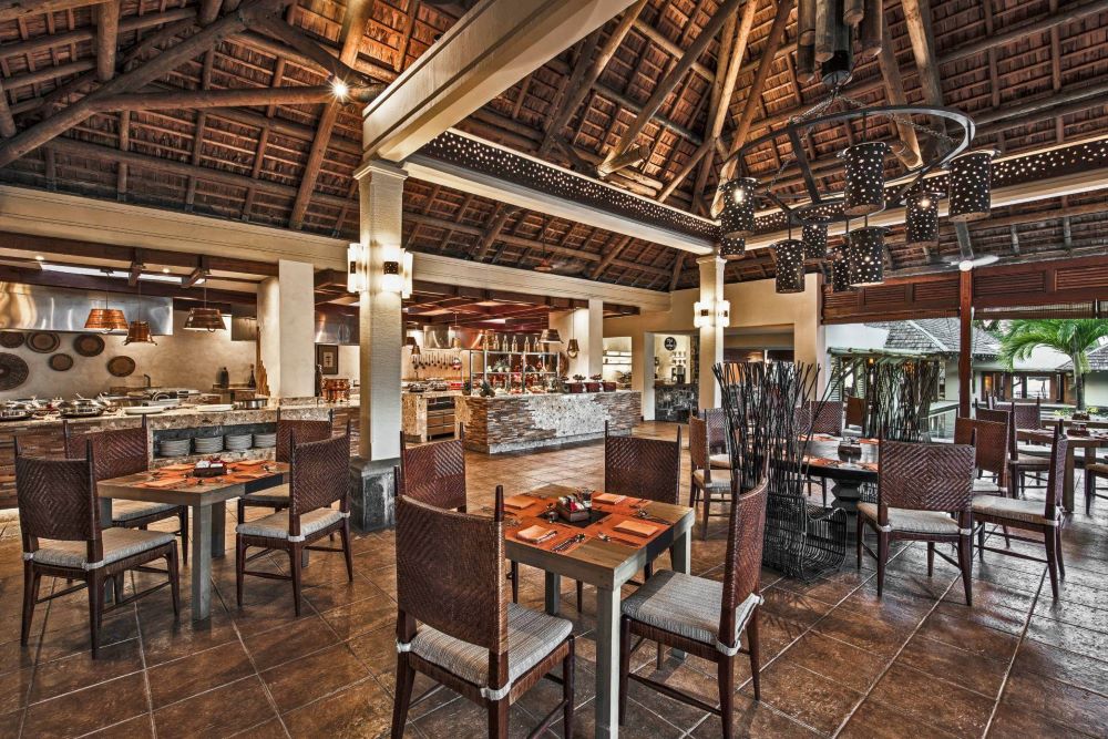 Restaurant with wooden chairs at Heritage Awali Golf & Spa Resort