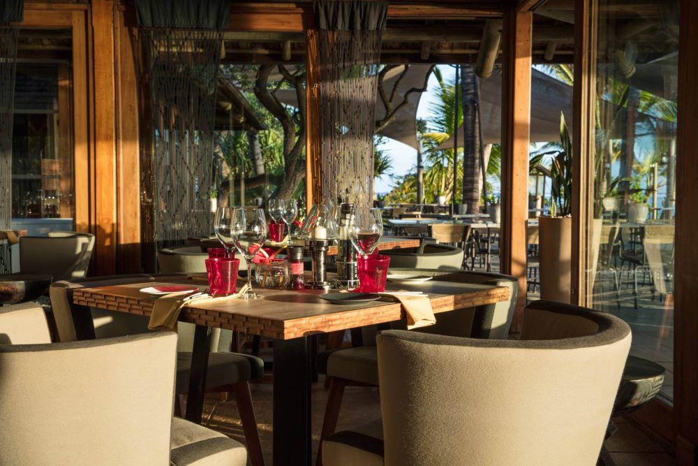 Table and chairs set for service in the restaurant at Heritage Awali Golf & Spa Resort