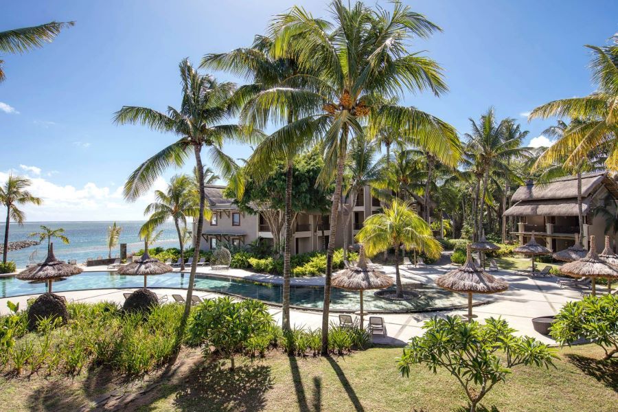 Swimming pool surrounded by plants and trees at Heritage Awali Golf & Spa Resort