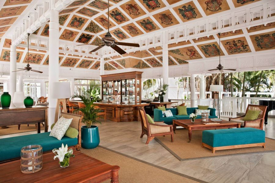 Green chairs in bar area at Heritage Le Telfair Golf & Wellness Resort in Mauritius