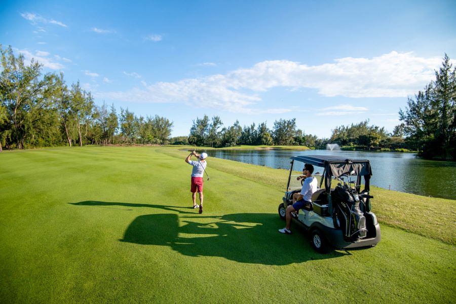 Buggy on the course at golfer tees off at Ile aux Cerfs Golf Club