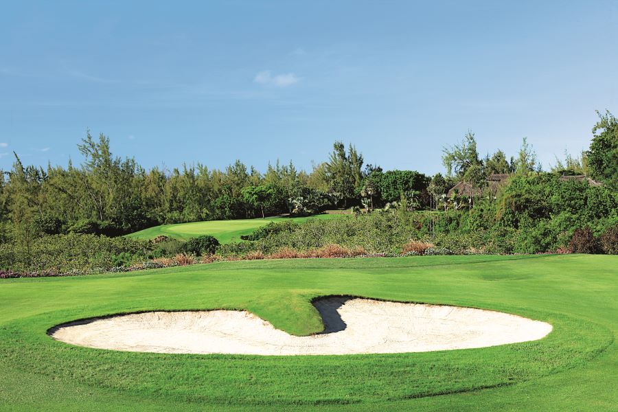 Sandy bunker under blue sky at Ile aux Cerfs Golf Club