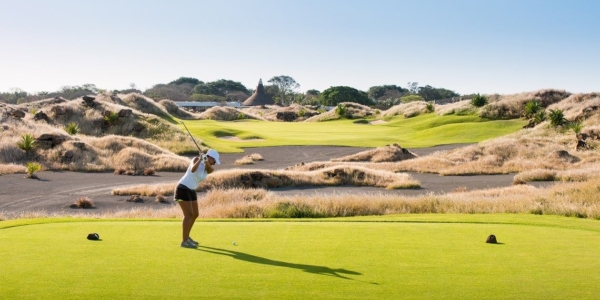 Golfer teeing off at Mont Choisy Le Golf course in Mauritius