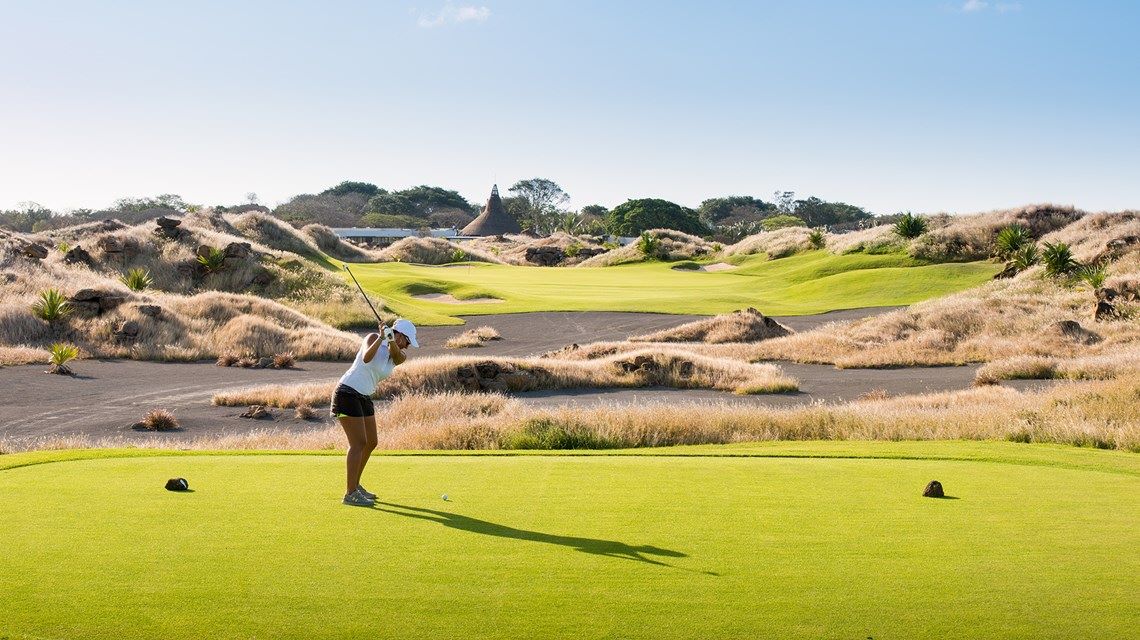 Golfer teeing off at Mont Choisy Le Golf course in Mauritius