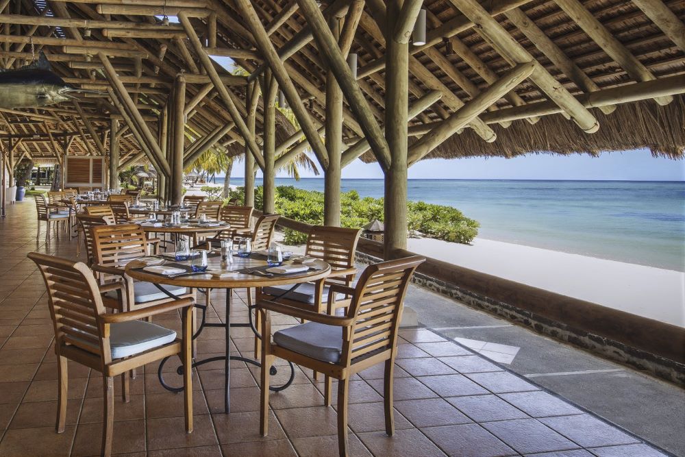 Seats and chairs overlooking beach at Paradis Beachcomber Golf Resort & Spa