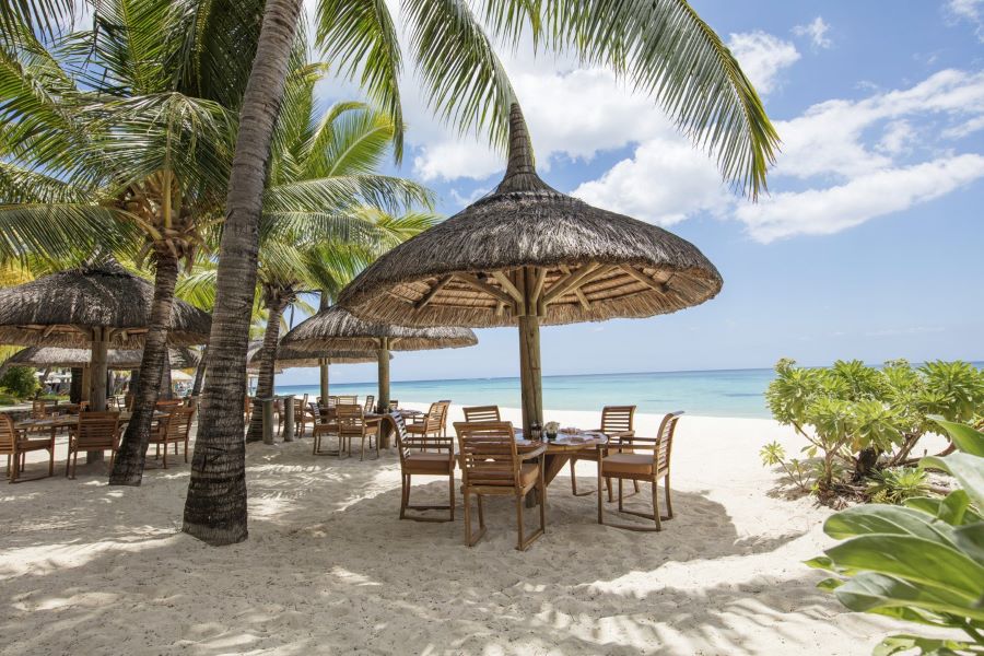 Table and chairs on beach at Paradis Beachcomber Golf Resort & Spa