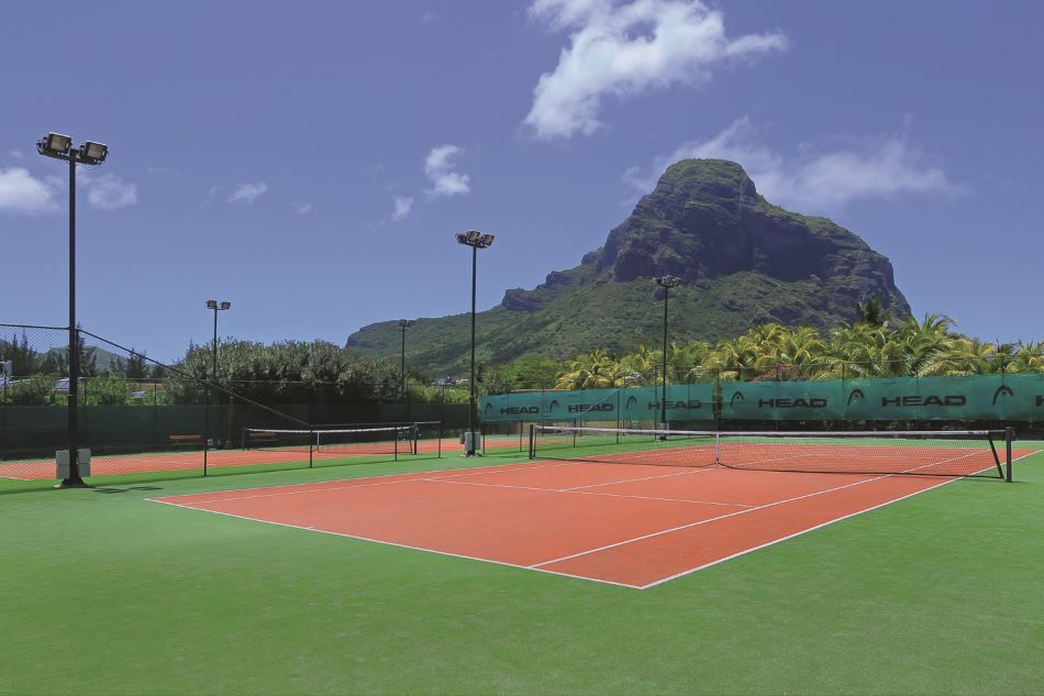 Tennis courts with mountain scenery at Paradis Beachcomber Golf Resort & Spa in Mauritius