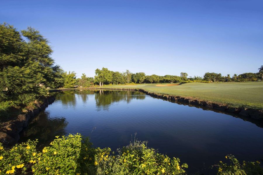 Blue lake by the fairway at Tamarina Golf Club