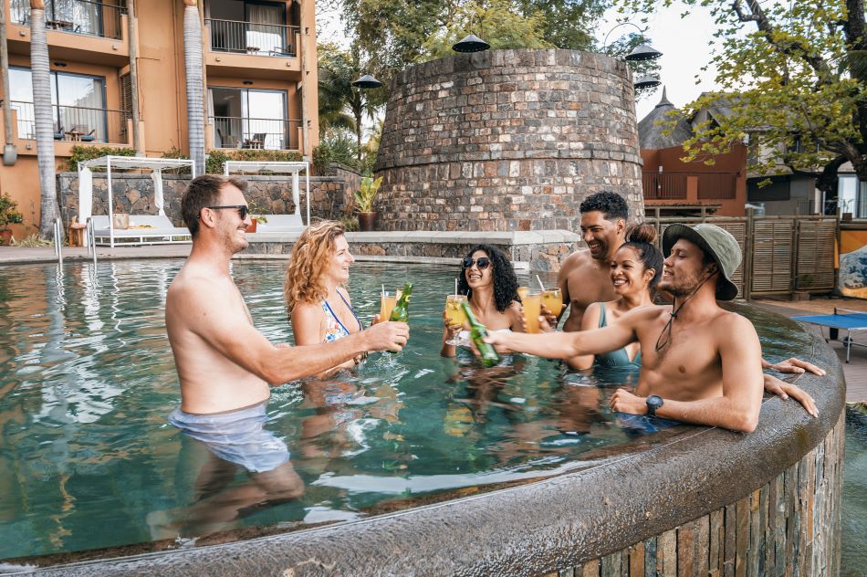 Friends in swimming pool at Tamarina Golf & Spa Boutique Hotel