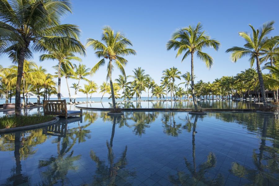 Swimming pool leading to palm trees at Trou aux Biches Beachcomber Golf Resort & Spa