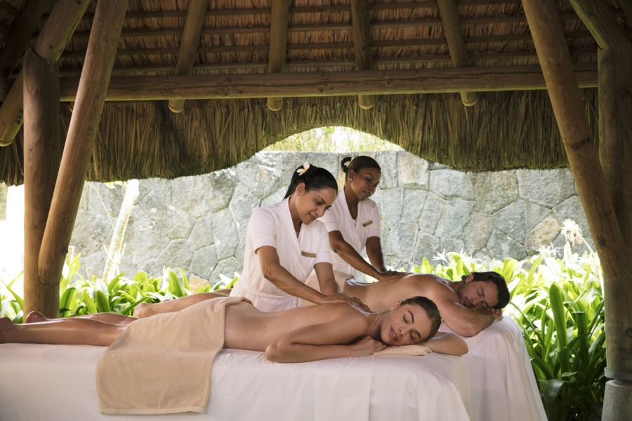 Couple enjoying massage from therapists at Trou aux Biches Beachcomber Golf Resort & Spa